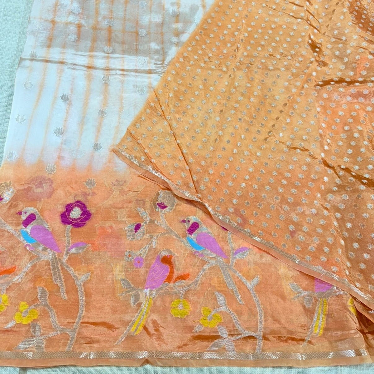 Lightweight orange paper silk saree with gold zari border and meena weave motifs