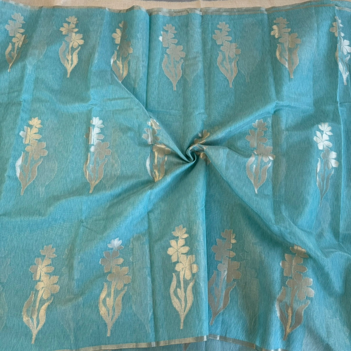 Sky blue paper silk saree with fine zari lines and floral zari weaving