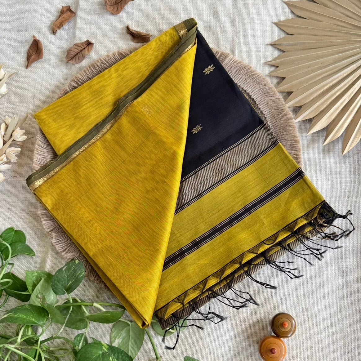 Yellow silk cotton saree with black pallu and elegant finish