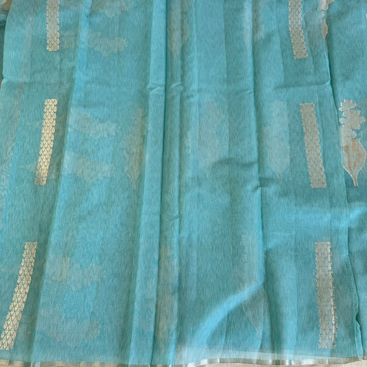 Sky blue paper silk saree with fine zari lines and floral zari weaving
