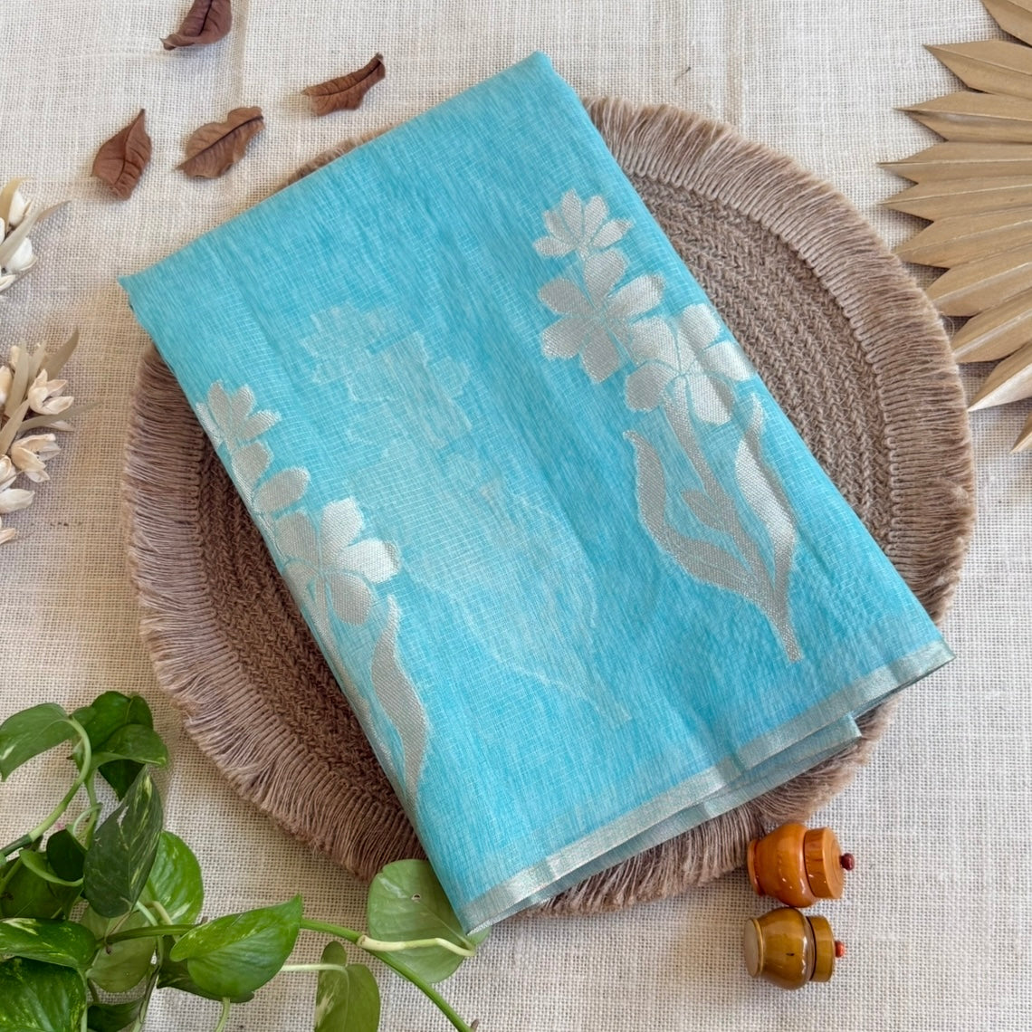 Sky blue paper silk saree with fine zari lines and floral zari weaving
