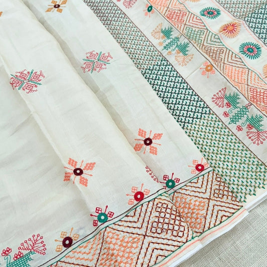 Close view of geometric Kutch embroidery on ivory semi tussar saree
