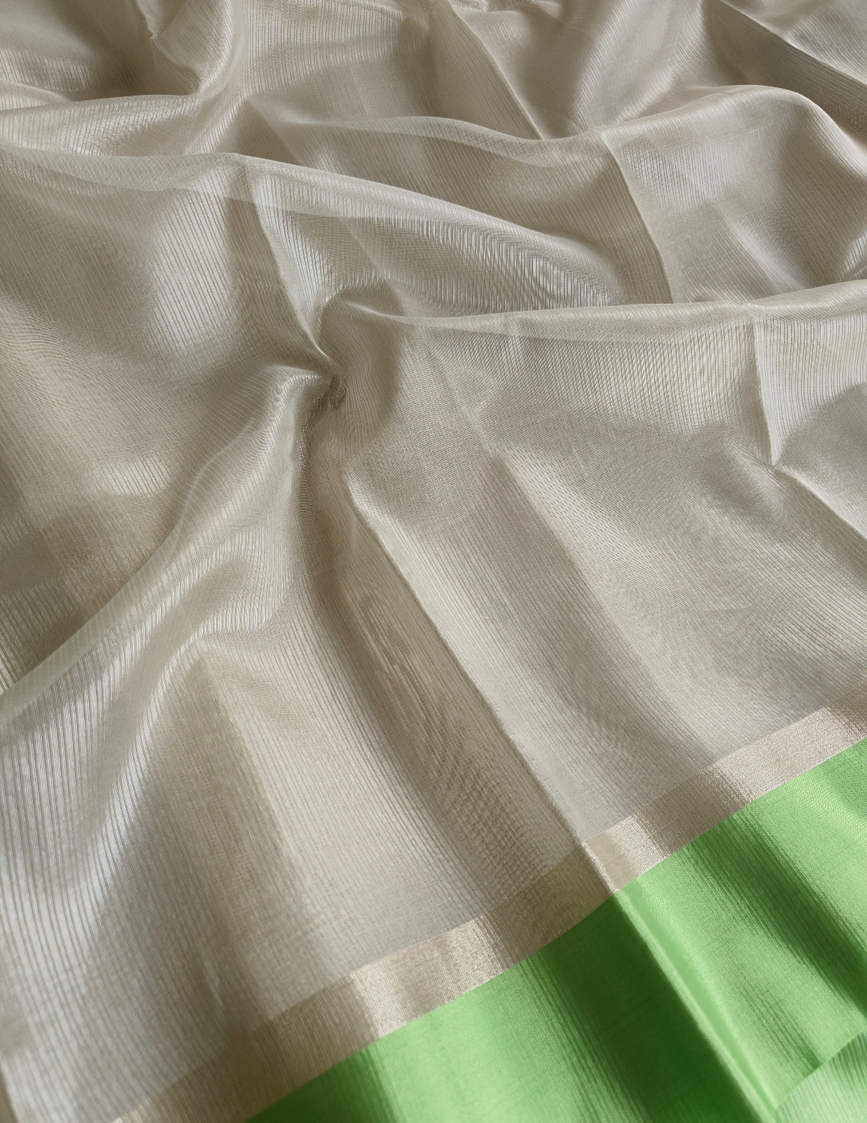 Ivory Tissue Parrot Green Border Saree